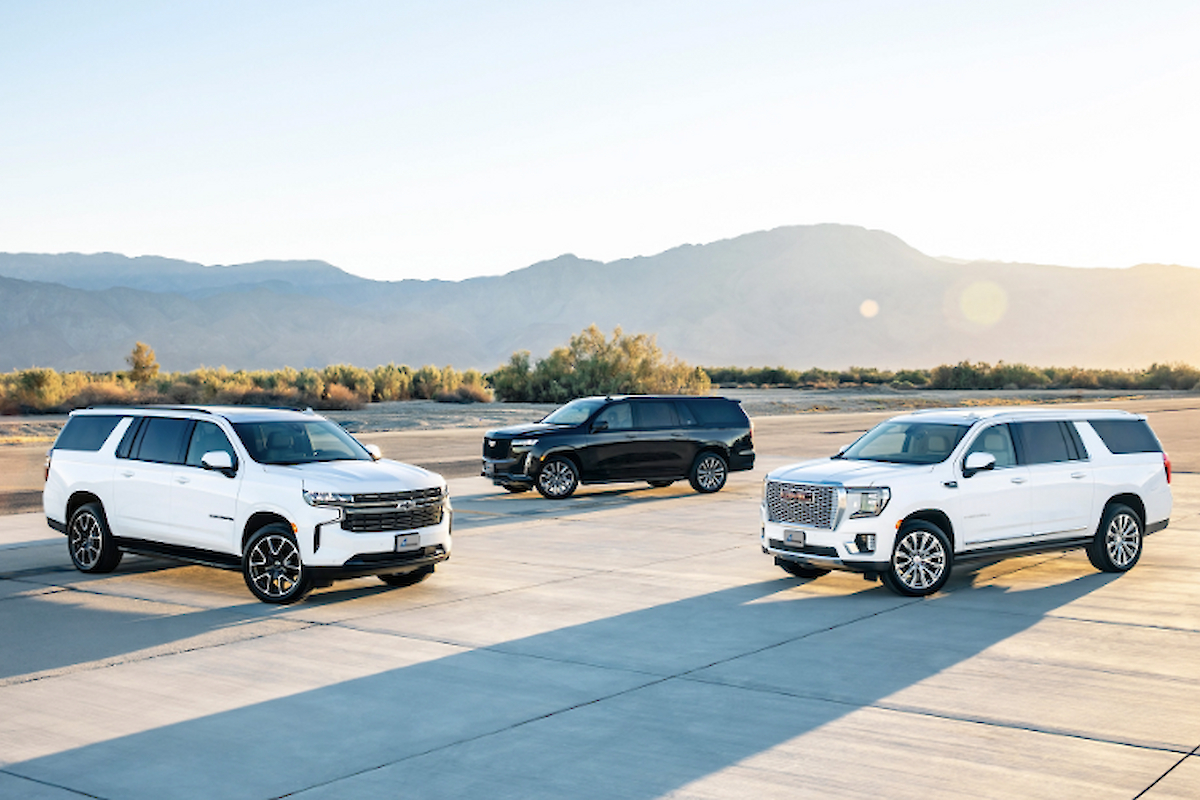 The image features three SUVs parked on an open area with a mountainous background, highlighting their sleek designs and colors.